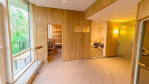 A modern interior with wooden paneling, a glass door leading outside, and a bench by the window.