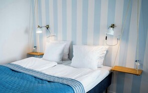 A bed with white linens, a blue blanket, and two bedside tables with lamps. - Aalbaek Badehotel, Sure Hotel Collection by Best Western (Aalbaek)