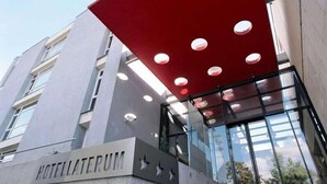 A modern hotel entrance with a prominent sign reading "HOTELLATERUM." - Laterum Conference And Wellness (Pecs)