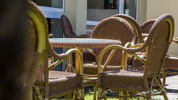 Wicker furniture with a glass top table and chairs, positioned outdoors with a building in the background. - Columbano Hotel Residencial (Peso da Régua)