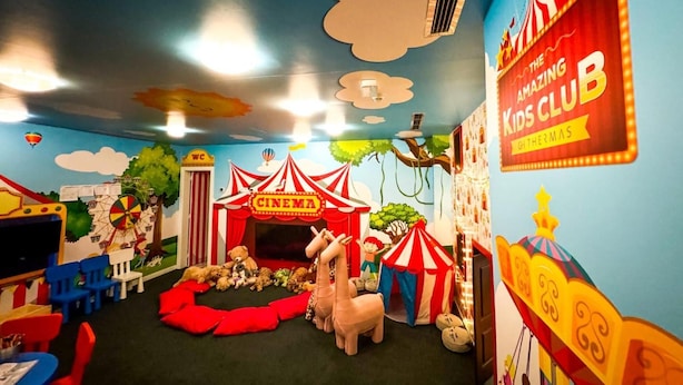 A children's playroom with a cinema theme, including a red and white striped tent labeled 'CINEMA', a carousel, and various play items. - Grande Hotel Lisboa (Sao Pedro do Sul)