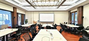 A conference room with multiple tables and chairs, a projector screen, and large windows. - Pipaxi Hunan Zhangjiajie (Zhangjiajie)