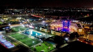 A large hotel complex with multiple buildings, a swimming pool, and a sports field. - Guard Hotel (Cairo)