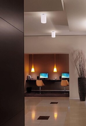 A modern reception area with two computer monitors, a reception desk, and two chairs. - Elefsina (Elefsina)