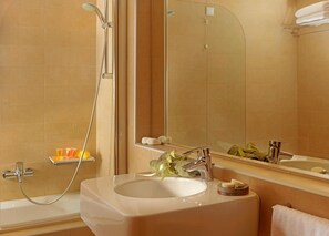 Un bany modern amb banyera, un lavabo i un mirall gran.