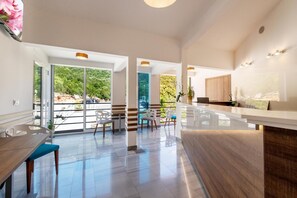 A spacious kitchen with a large island, modern appliances, and a view of greenery outside. - Hotel Porat (Neum)