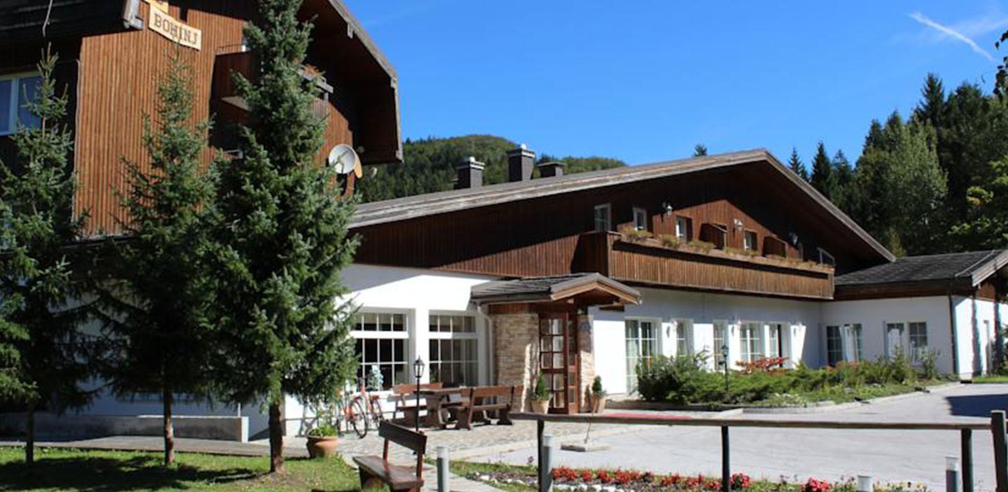 A building with a wooden facade, large windows, and a stone entrance.