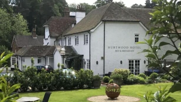 A white building labeled "HURTWOOD HOTEL BED & BREAKFAST" with a garden in front. - The Hurtwood Inn Hotel (Guildford)