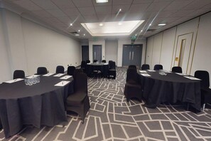 A conference room with round tables, chairs, and a patterned carpet. - Village Birmingham Dudley Hotel Leisure Club (Dudley)