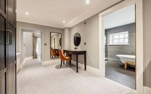A modern bathroom with a bathtub, a toilet, and a sink. - The Vale Golf Club (Pontyclun)