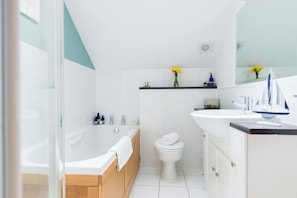 A modern bathroom with a bathtub, toilet, and sink. - Retallack Resort And Spa (St. Columb Major)