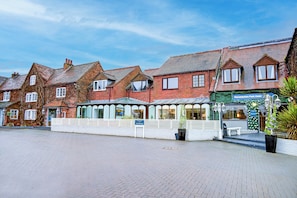 A hotel with traditional architecture, a paved courtyard, and a sign indicating parking availability. - The Warwick Hotel by Colombo Edition (Kenilworth)