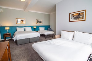 A hotel room with two beds, a desk, and a chair. There are framed pictures on the wall and a lamp on the desk. - Best Western Middlesbrough (Middlesbrough)