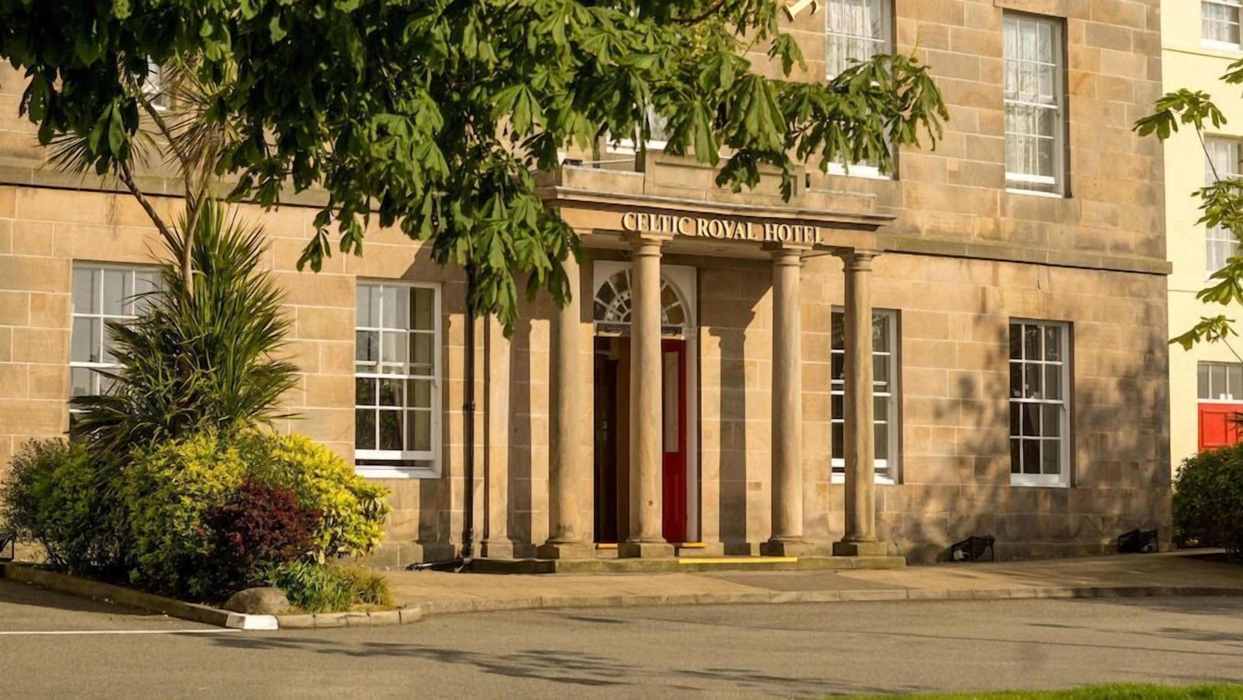 The Celtic Royal Hotel with a classical facade, large windows, and a prominent entrance with columns.