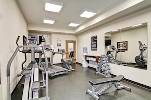 A gym with treadmills, weight machines, and a bench. - Weyburn Canalta Hotel (Weyburn)