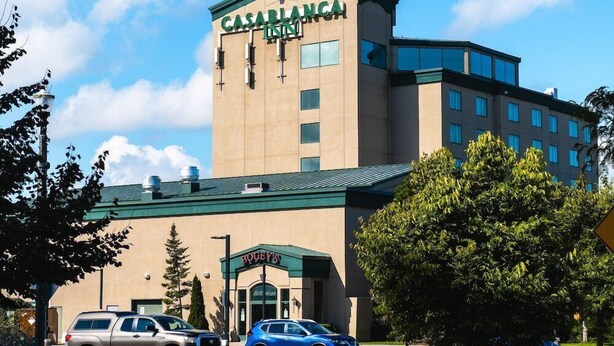 A hotel named Casablanca Inn with a modern architectural design, featuring a prominent tower and a green roof. - Casablanca Winery Inn (Grimsby)
