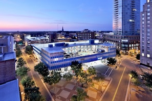 A modern building with a glass facade, surrounded by trees and streets. - Unscripted Durham (Durham)