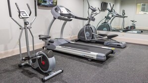 A gym with Nautilus elliptical machines, a treadmill, and a stationary bike. - Howard Johnson Inn Tybee Island Savannah Ga (Tybee Island)