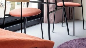 Un coin repas avec une table dressée pour deux personnes, où l’on trouve un sandwich et des boissons.