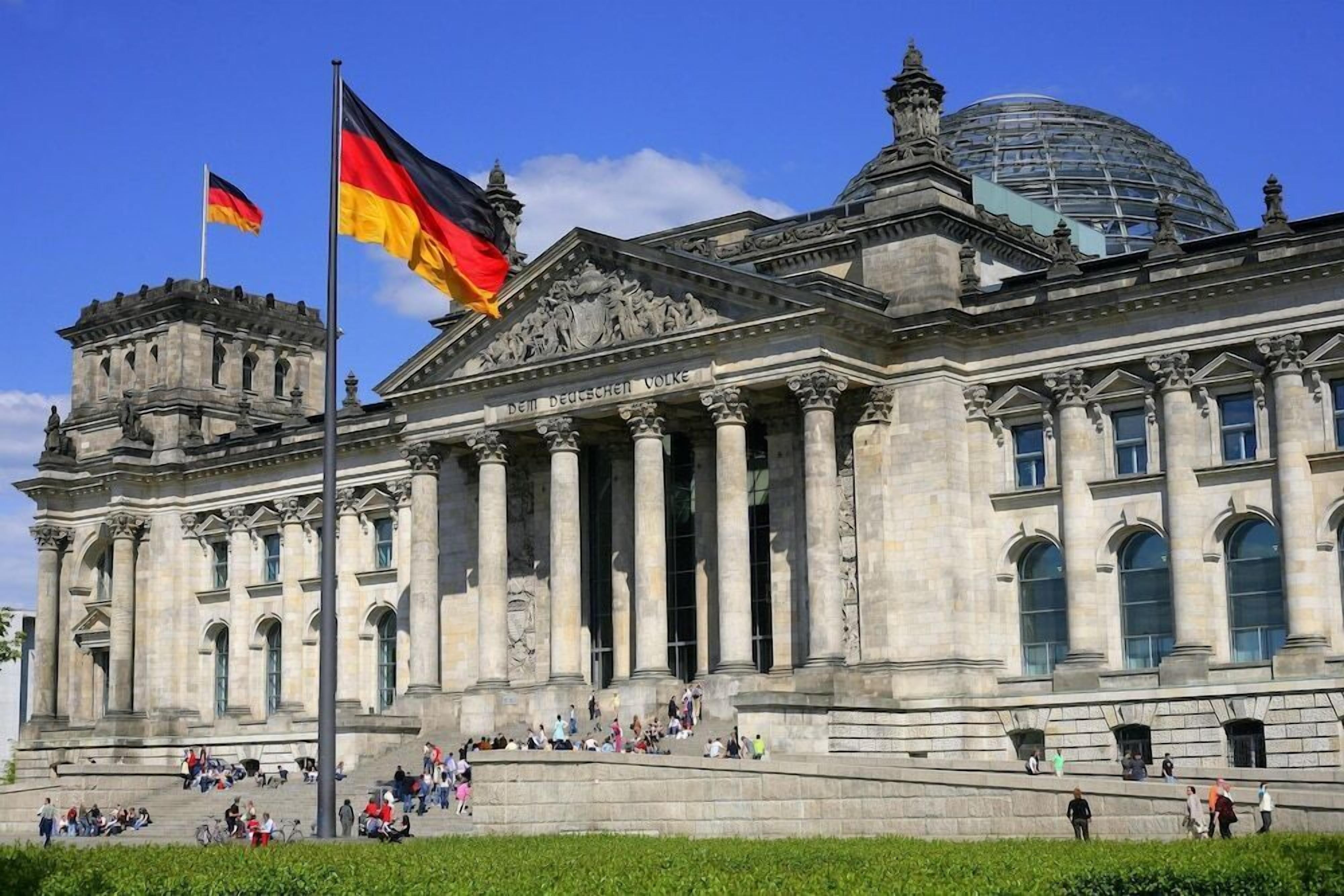 A large, historic building with classical architecture, featuring columns and a dome.