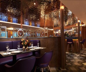 A restaurant with a bar area, purple seating, and a decorative ceiling. - Fingal A Luxury Floating Hotel (Edinburgh)