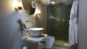 A modern bathroom with a large mirror, a round sink, a toilet, and a shower area. - Fingal A Luxury Floating Hotel (Edinburgh)