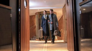 A hotel lobby with wooden paneling, a reception desk, and a staircase leading to an upper floor. - Fingal A Luxury Floating Hotel (Edinburgh)