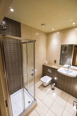 A modern bathroom with a glass-enclosed shower, a toilet, and a sink. - Classic Lodges Farington Lodge (Leyland)