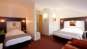A hotel room with two beds, a small seating area, and a door leading to a bathroom. - Jum Hotel - Auberge Des 3 Jumeaux (Saints-Geosmes)