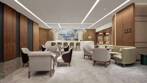 A modern lobby with a reception desk, seating area, and a bar. - Genpla Hotel Shenzhen Nanshan (Shenzhen)