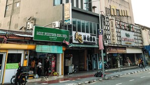 A hotel with a modern facade, multiple floors, and a prominent sign. - Palette Georgetown Formerly WoW Hotel (George Town)