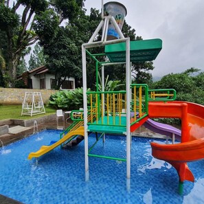 A children's play area with a water slide, a climbing structure, and a small pool. - Hotel Ariandri (Cisarua)