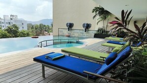A poolside area with lounge chairs and a view of the pool.