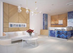 A hotel reception area with a reception desk, a sofa, a coffee table, and a chandelier. - Hotel 88 Banjarmasin (Banjarmasin)