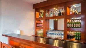 A bar area with shelves stocked with various bottles and cans. - Hotel Shangri-la Regency (Darjeeling)