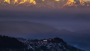 A mountain range with a town at the base. - Hotel Shangri-la Regency (Darjeeling)