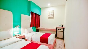 A hotel room with two beds, a desk, a nightstand, a red curtain, and a painting on the wall. - Lumut Suites (Lumut)