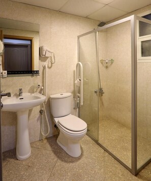 A bathroom with a toilet, sink, and glass-enclosed shower. - Al Smou Hotel Apartments - Maha Hospitality Group (Ajman)