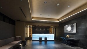 A modern lobby with a reception desk, seating area, and a large abstract painting on the wall. - Tmark City Hotel Kanazawa (Kanazawa)