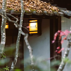 A traditional building with a tiled roof and a sign with Chinese characters. - Hotarunoyado Sendou (Yufu)