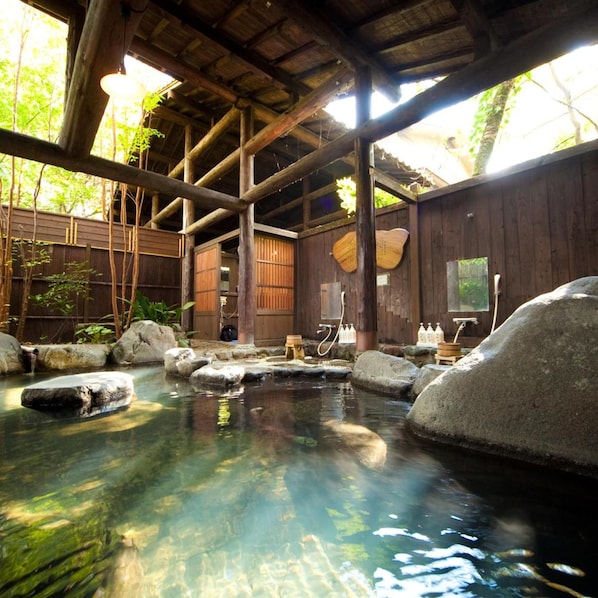 A traditional wooden structure with a clear water feature in the foreground. - Hotarunoyado Sendou (Yufu)