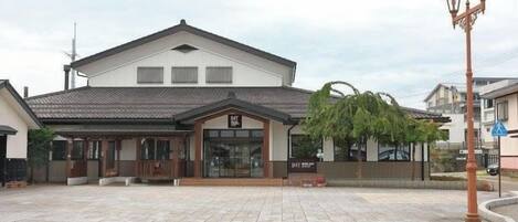 A building with a tiled roof, a covered entrance, and a sign that reads "B1".