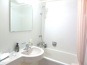 A bathroom with a sink, mirror, shower, and a towel rack. - Hotel Folkloro Kakunodate (Senboku)