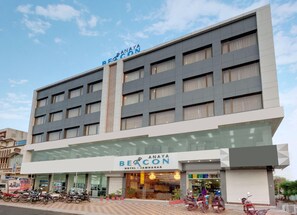 A multi-story hotel building with a sign reading 'BEACON HOTEL JAMNAGAR.' - Anaya Beacon Hotel (Jamnagar)