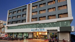 A multi-story hotel with a prominent sign for 'Anaya Beacon Hotel - Jamnagar.' - Anaya Beacon Hotel (Jamnagar)
