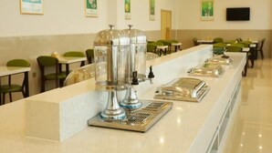 A buffet setup with clear glass dispensers and a stainless steel serving tray. - Greentree Inn Anqing Huaining County Development Zone Duxiu Road (Anqing)
