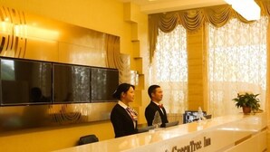 A reception desk with a sign reading "GreenTree Inn". - Greentree Inn Anqing Huaining County Development Zone Duxiu Road (Anqing)
