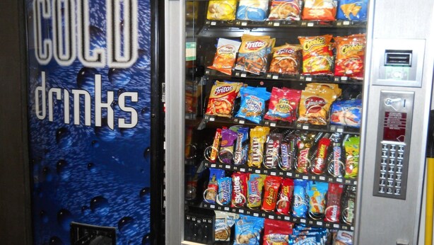 A vending machine with a 'COLD drinks' sign and various snacks and beverages.