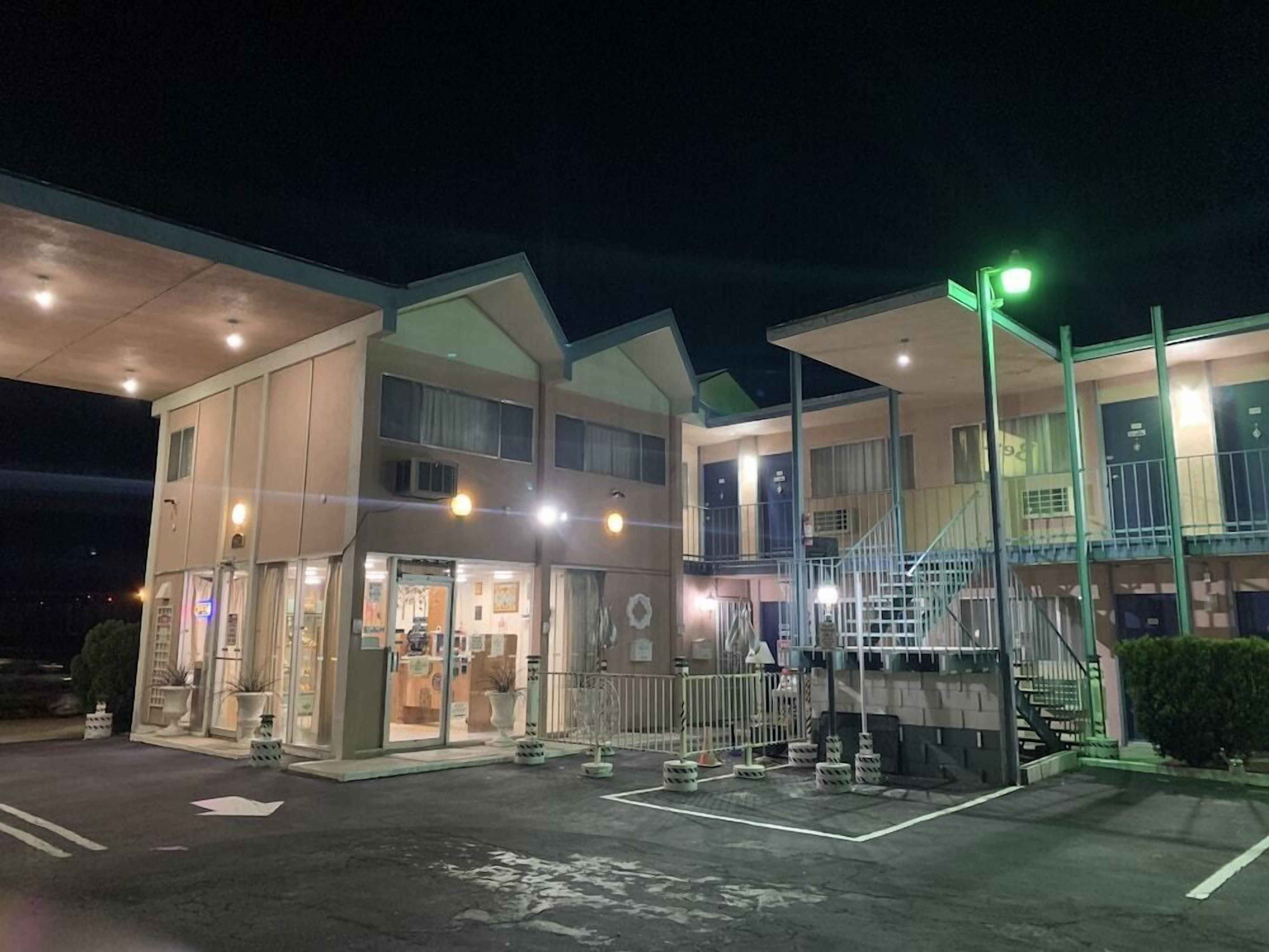 A multi-story hotel with a ground-level restaurant and a staircase leading to upper floors.