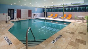 An indoor swimming pool with clear water, surrounded by lounge chairs and a tiled floor. - Holiday Inn Express And Suites Dahlonega University Area, an IHG Hotel (Dahlonega)